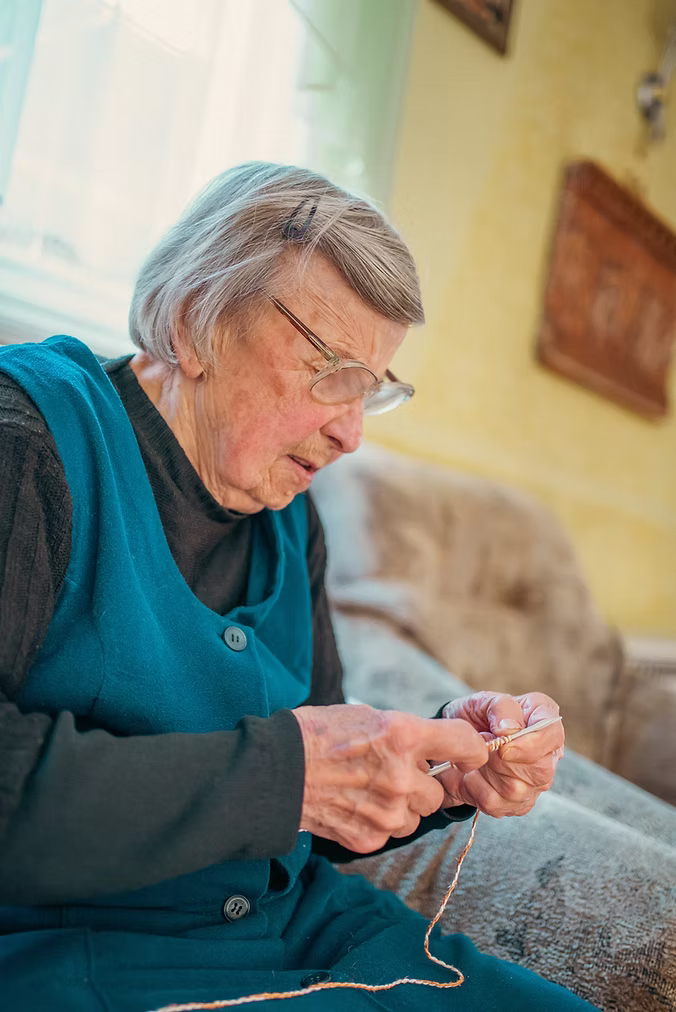 Elderly woman knitting